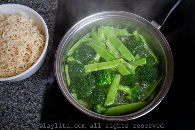 Inmediatamente, agregue los floretes de brócoli y cocine todo junto cinco minutos más.