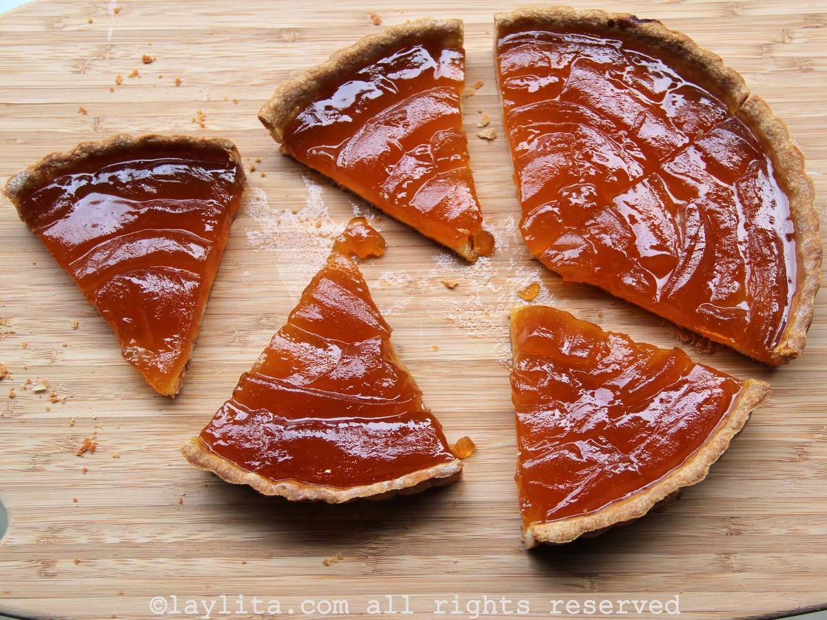 Un pastel o pay de babaco en una tabla de madera cortado en varios pedazos