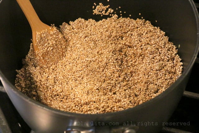 Stir the quinoa with onion and garlic until coated