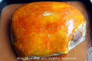 Drizzle and rub the achiote (annatto) butter mix over the pork skin