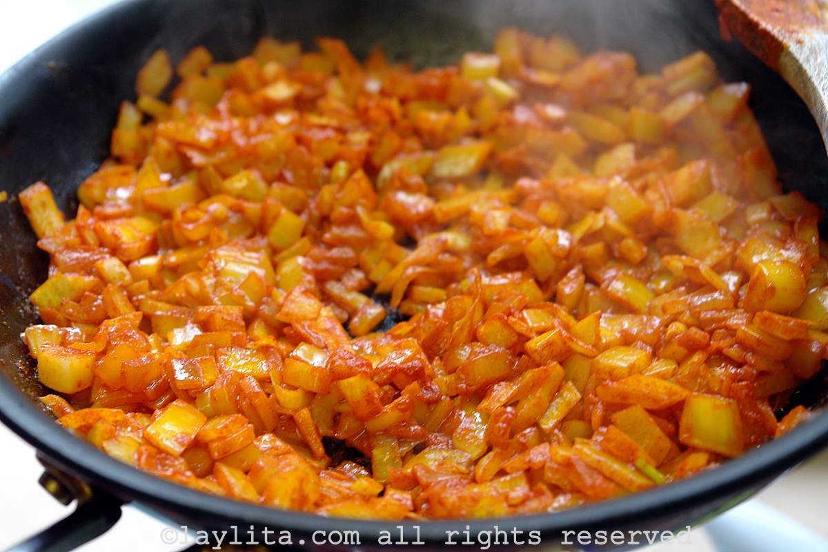 Simple refrito or sofrito made with diced onion, garlic, cumin, achiote, salt and oil