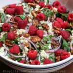 Spinach raspberry salad with gorgonzola and honey roasted walnuts