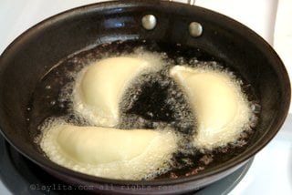 Fry the empanadas in hot oil until golden on each side