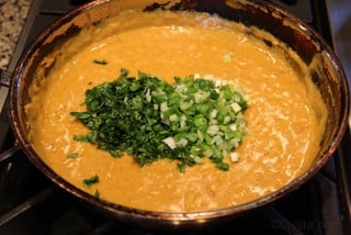 Add cilantro and chopped scallions to the peanut sauce