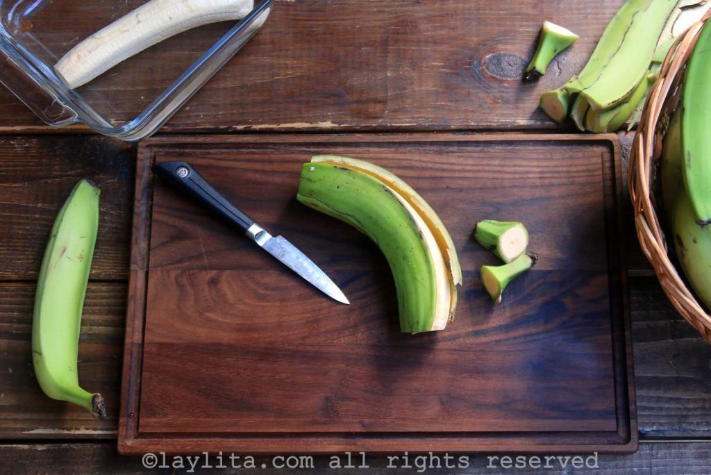 Peeling green plantains
