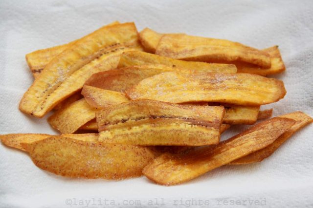 Place the green plantain chips on paper towels to remove any excess oil