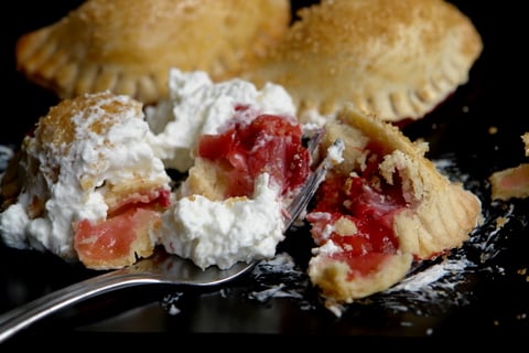 Rhubarb and strawberry empanadas with whipped cream