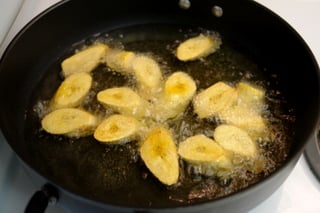 Frying patacones or tostones