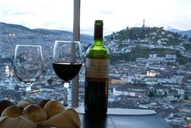 A glass of wine and a view of the city