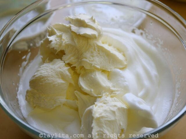 Use a spoon to add the mascarpone cheese to the egg whites, fold the mascarpone in gently.