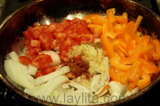 Cook the onions, tomatoes, bell peppers, garlic, achiote and cumin for about 10 minutes