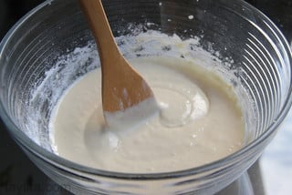 Use a spoon to slowly stir in the flour