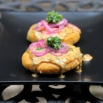 Stuffed hominy patties with peanut sauce, pickled onions and aji sauce