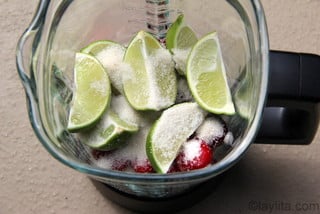 Place the cherries, limes, sugar and water in the blender