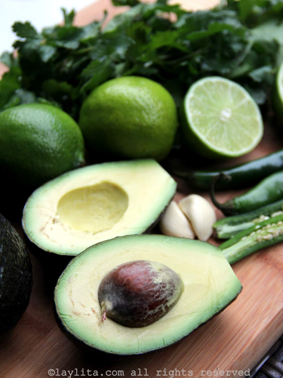 Ingredients for avocado salsa on a wood cutting board
