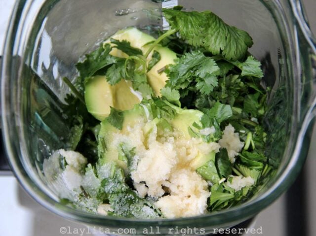 Ingredients for avocado sauce in a blender