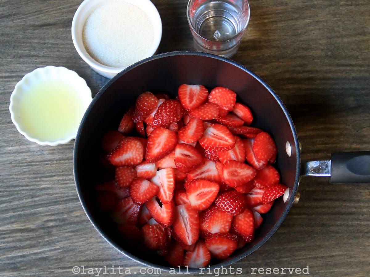 Ingredients for strawberry topping sauce on a kitchen counter