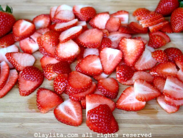Sliced strawberries on a cutting board