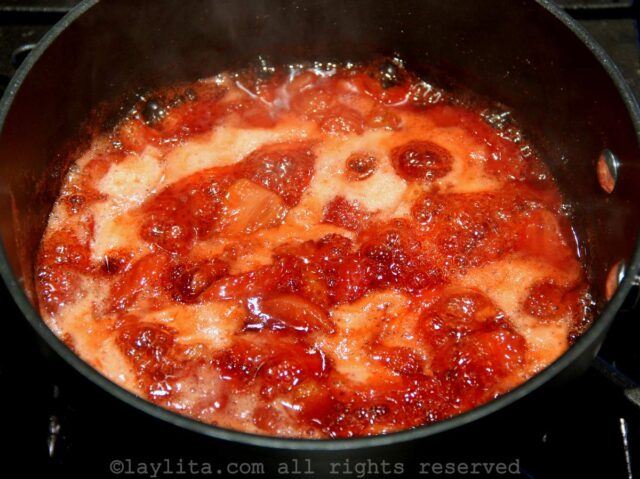Strawberry sauce cooking in a pot on the stove