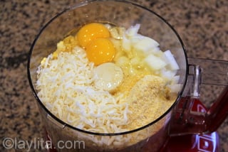 Use the food processor to blend the corn with 1 cup of cheese, the onion, eggs, cream and cornmeal
