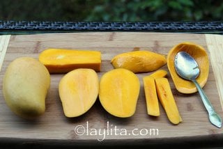 Scooping the flesh or pulp out of fresh mangos
