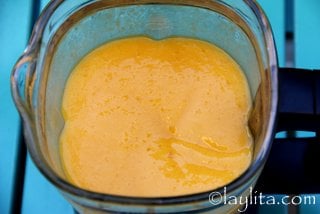 Blend the mango slices with passion fruit concentrate, lime juice, sugar, water and ice