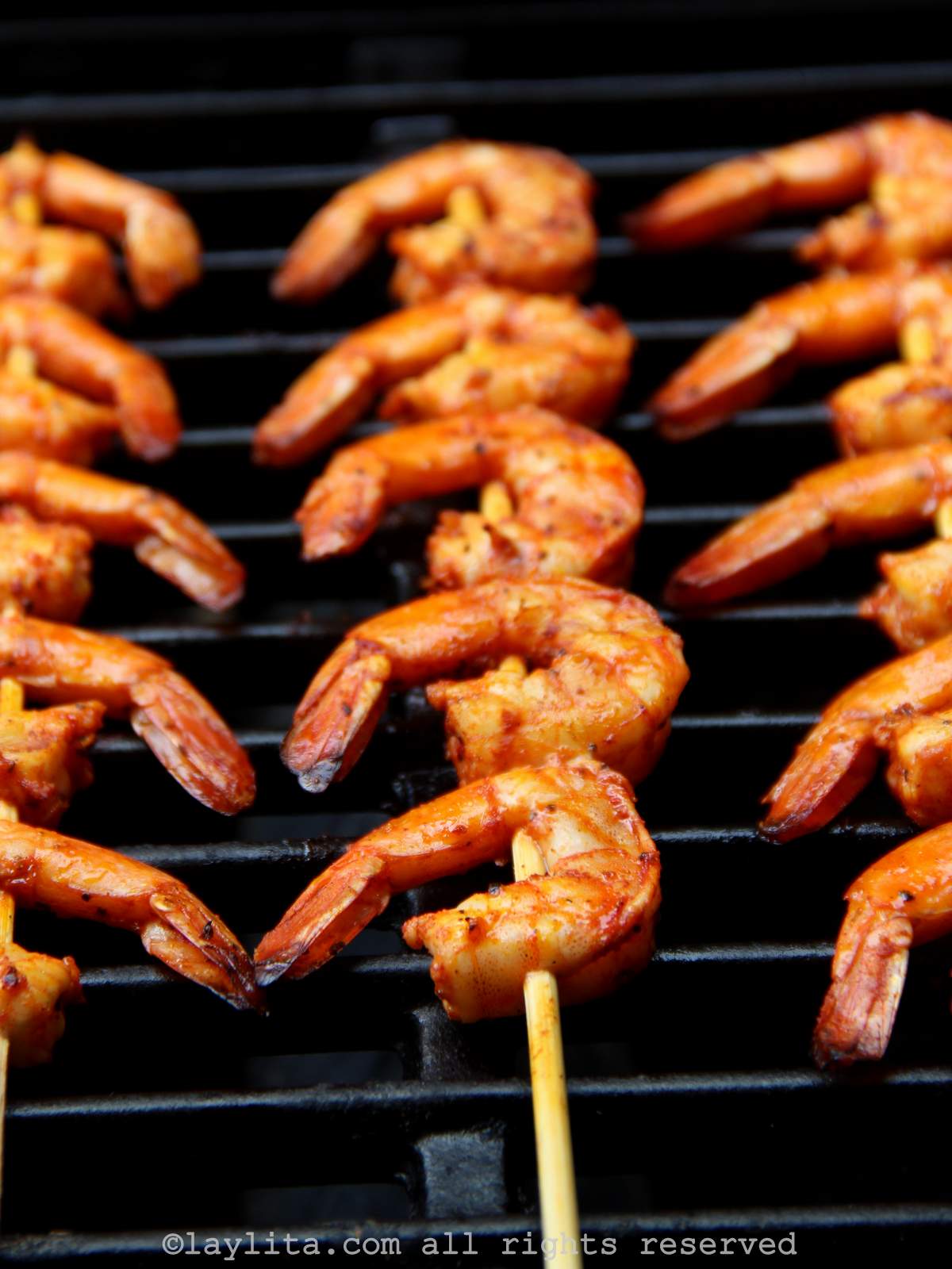 Three shrimp skewers on a grill