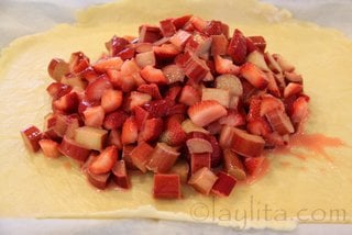 For the rustic tart, place the fruit filling on the center of the pastry dough