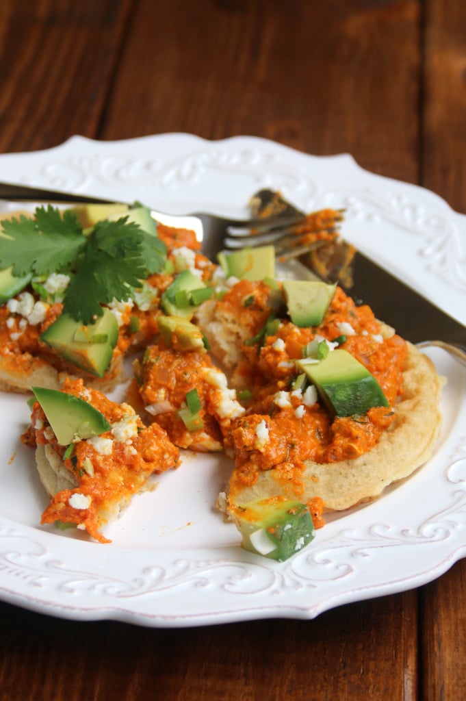 Waffles topped with tomato scrambled eggs, avocado and queso fresco
