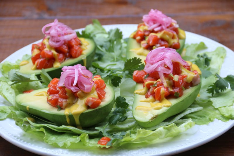 Salmon tartare filled avocados with pickled red onions