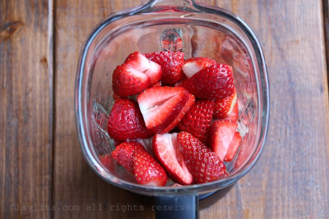 Blend the strawberries with sugar or honey, lime juice, and water