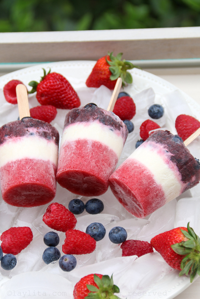 Red, white, and blue layered popsicles or paletas