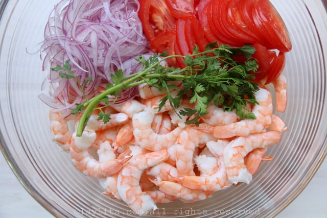 Marinate the shrimp, onions, and tomatoes with the lime juice and cilantro sprig for about 30 minutes