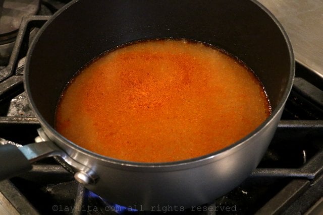 Strain the roasting pan juices and cook until reduced by half