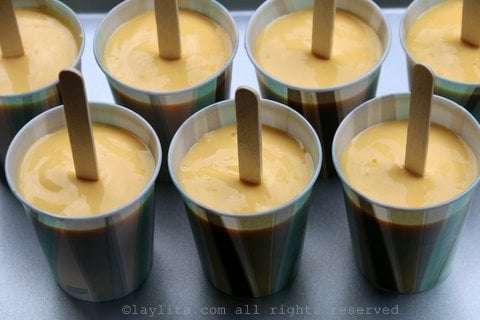Pour the mango smoothie mix into popsicle molds or small paper cups