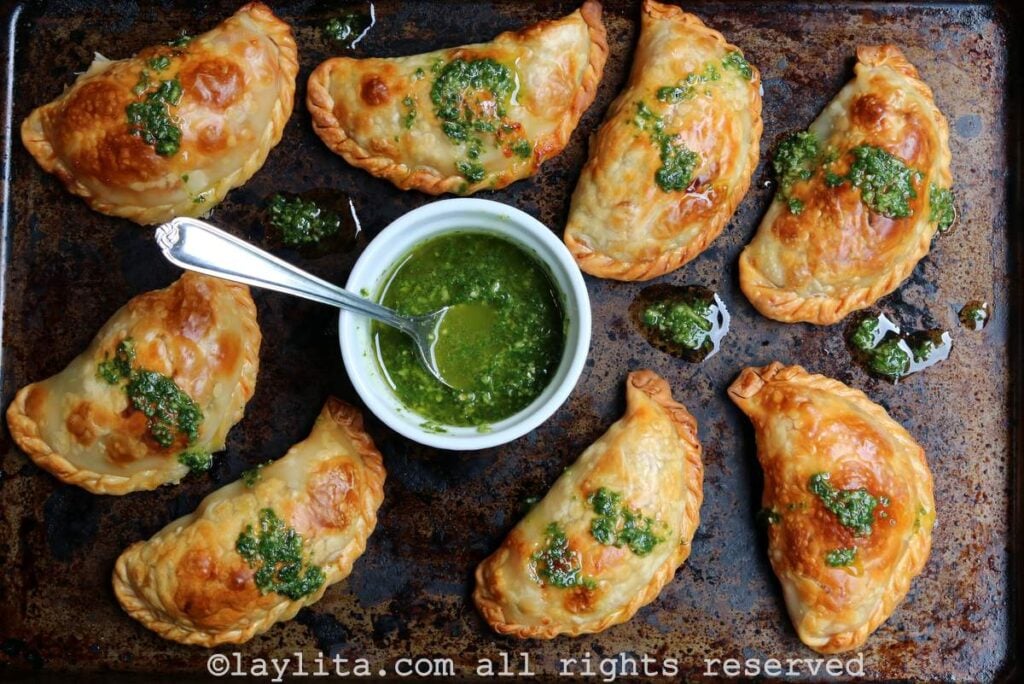Caprese empanadas with basil sauce Shot of caprese empanadas on a baking sheet served with basil garlic sauce