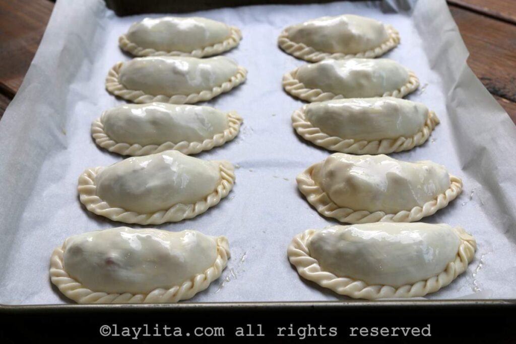 Brush the empanadas with egg wash before baking