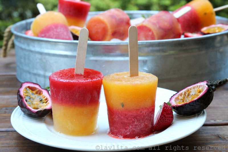 Layered strawberry passion fruit popsicles