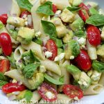 Avocado pasta salad with tomatos and cheese