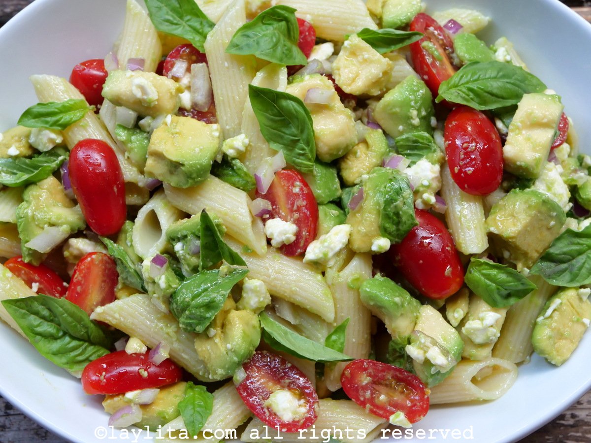 Avocado pasta salad with tomatoes and feta cheese or queso fresco