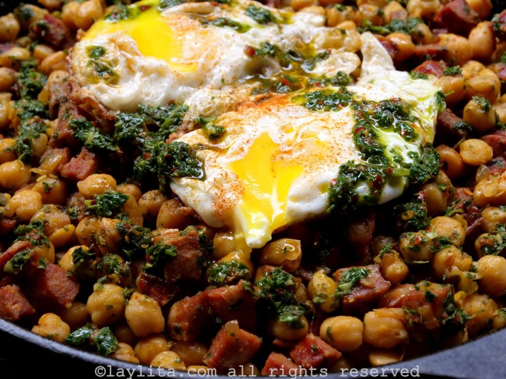 Chickpeas with chorizo and chimichurri, served with fried eggs