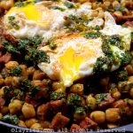 Chickpeas with chorizo and chimichurri, served with fried eggs