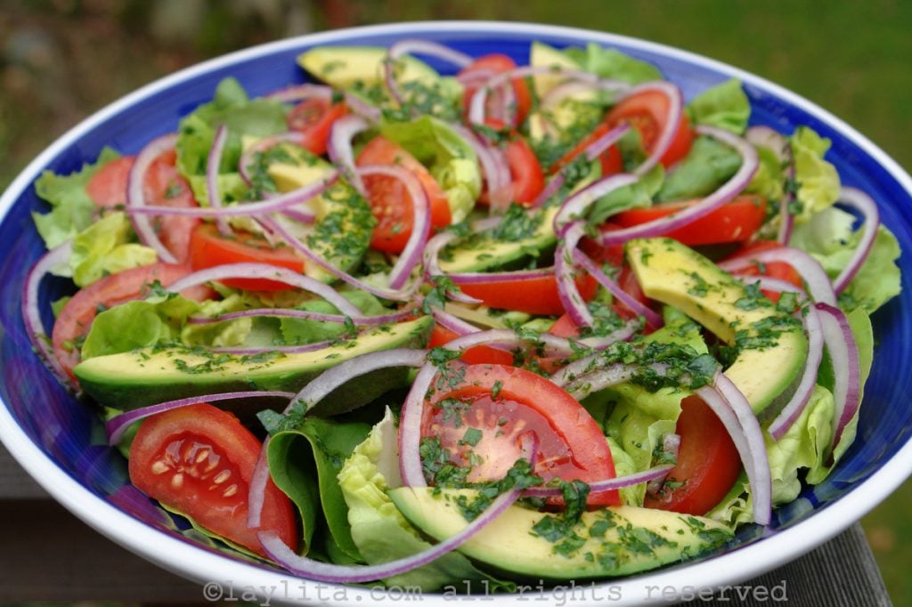 Tomato, avocado, lettuce and red onion salad with cilantro lime dressing