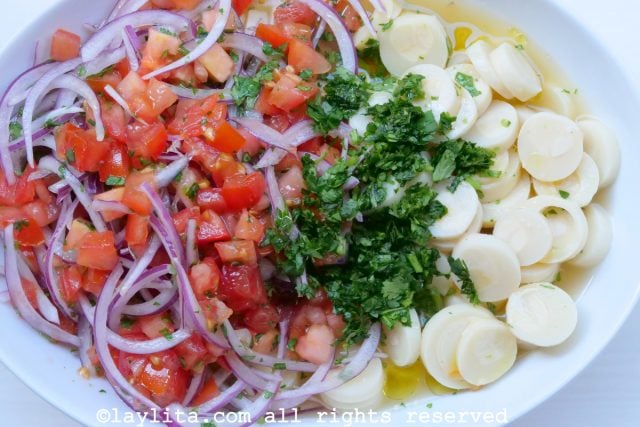 Add tomato and onion curtido salsa to hearts of palm ceviche mix