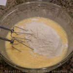 Add the sifted flour and baking powder, mix well using the electric mixer.