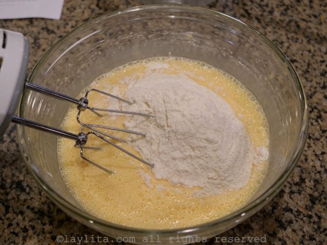 Add the sifted flour and baking powder, mix well using the electric mixer.