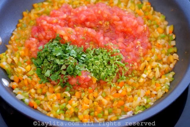 Add the diced or grated tomato and the diced cilantro stems