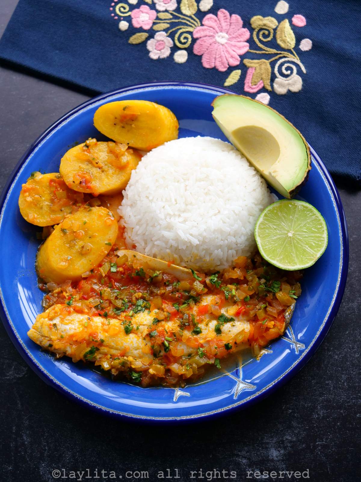 Fish stewed in tomatoes, onions and green pepper served with rice and avocado.