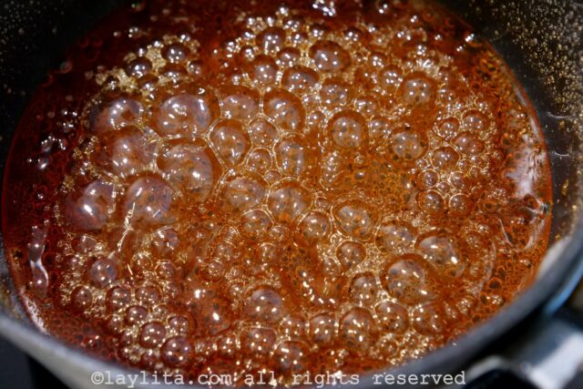 Caramel simmering in a saucepan.