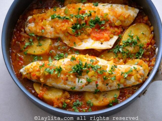 Preparing Ecuadorian sudado de pescado or fish stew in a skillet
